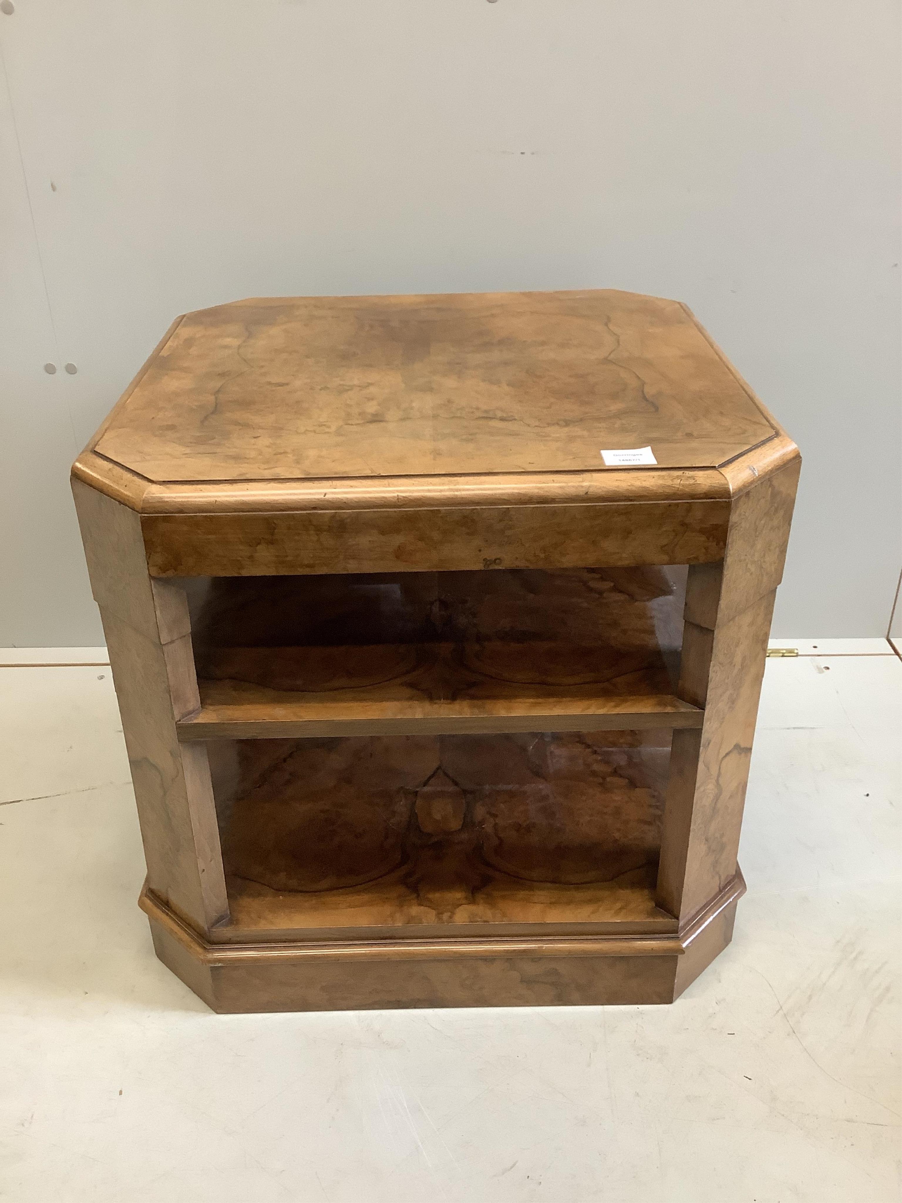 An Art Deco figured walnut octagonal three tier book table, width 61cm, depth 61cm, height 58cm. Condition - good